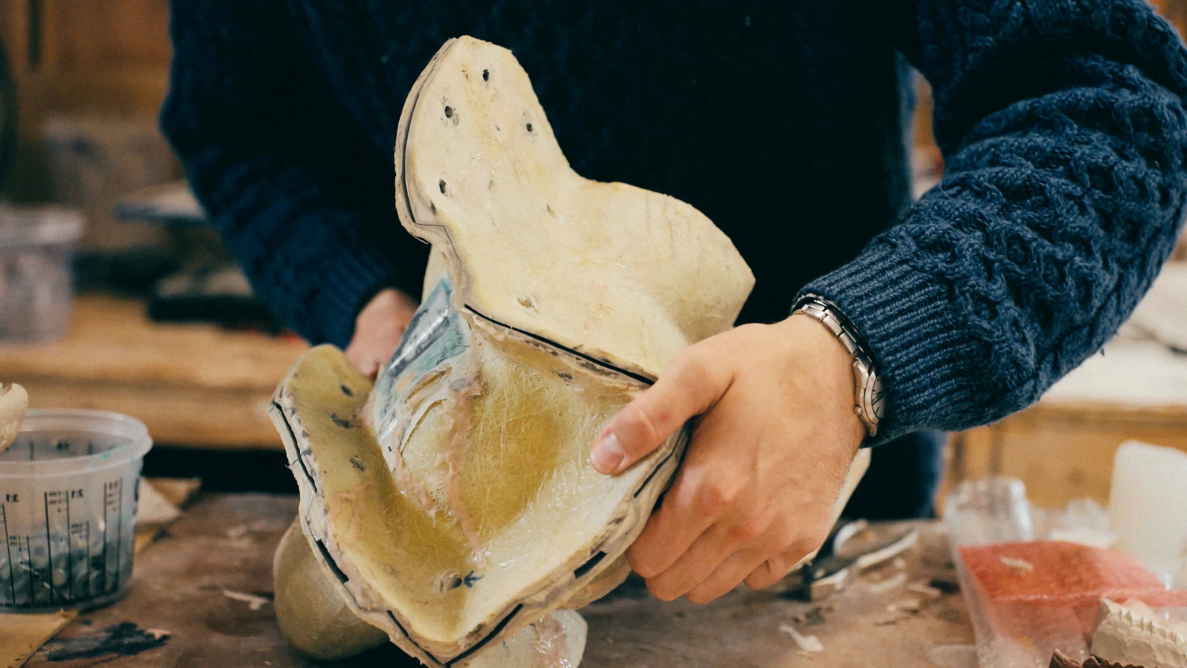Hands shaping the mould for the head