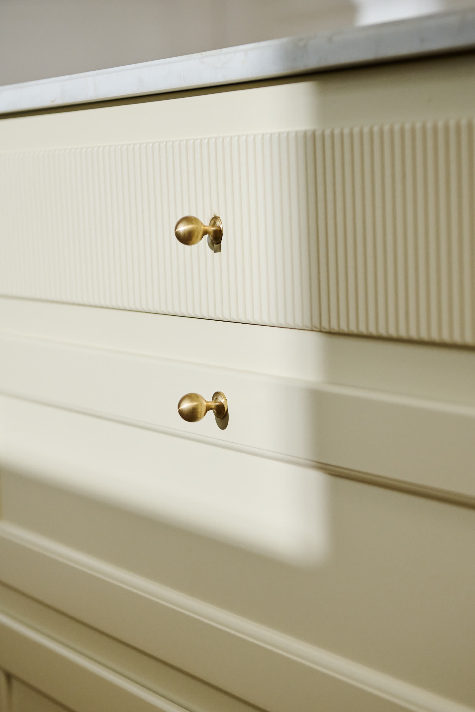 Brass knobs on the painted fronts