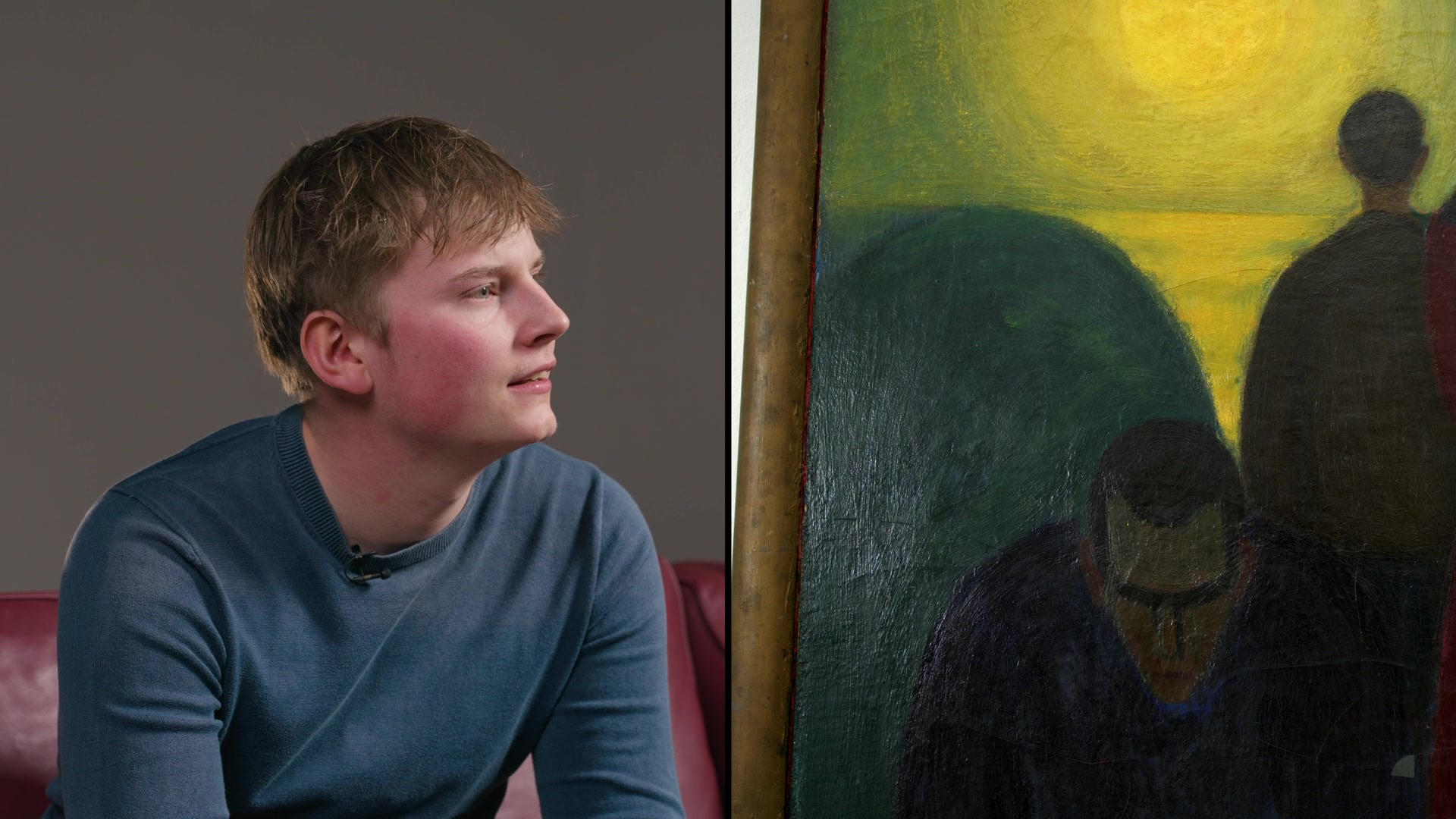 A young participant next to a painting with a yellow sky