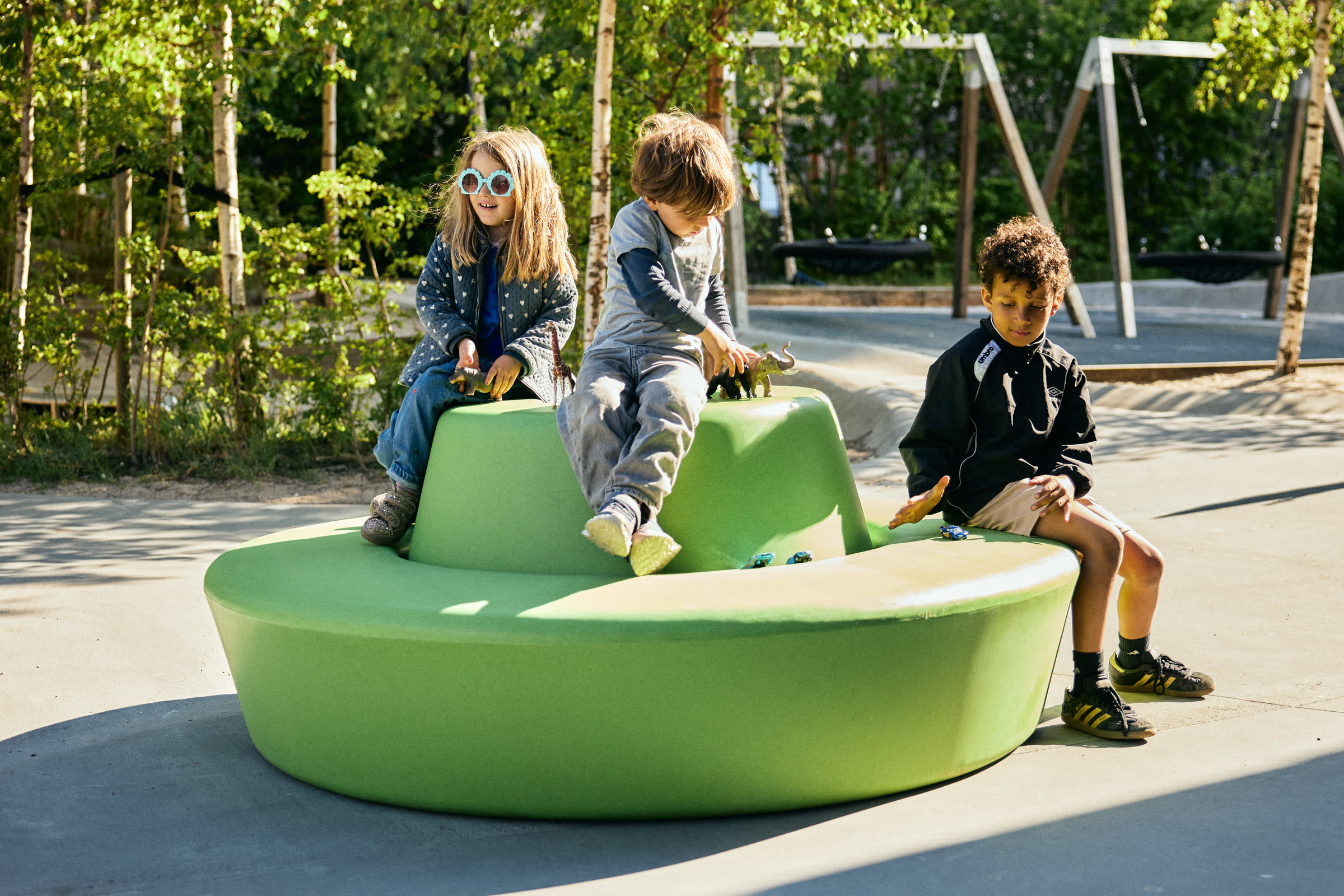 Children playing on a green LOOP circle