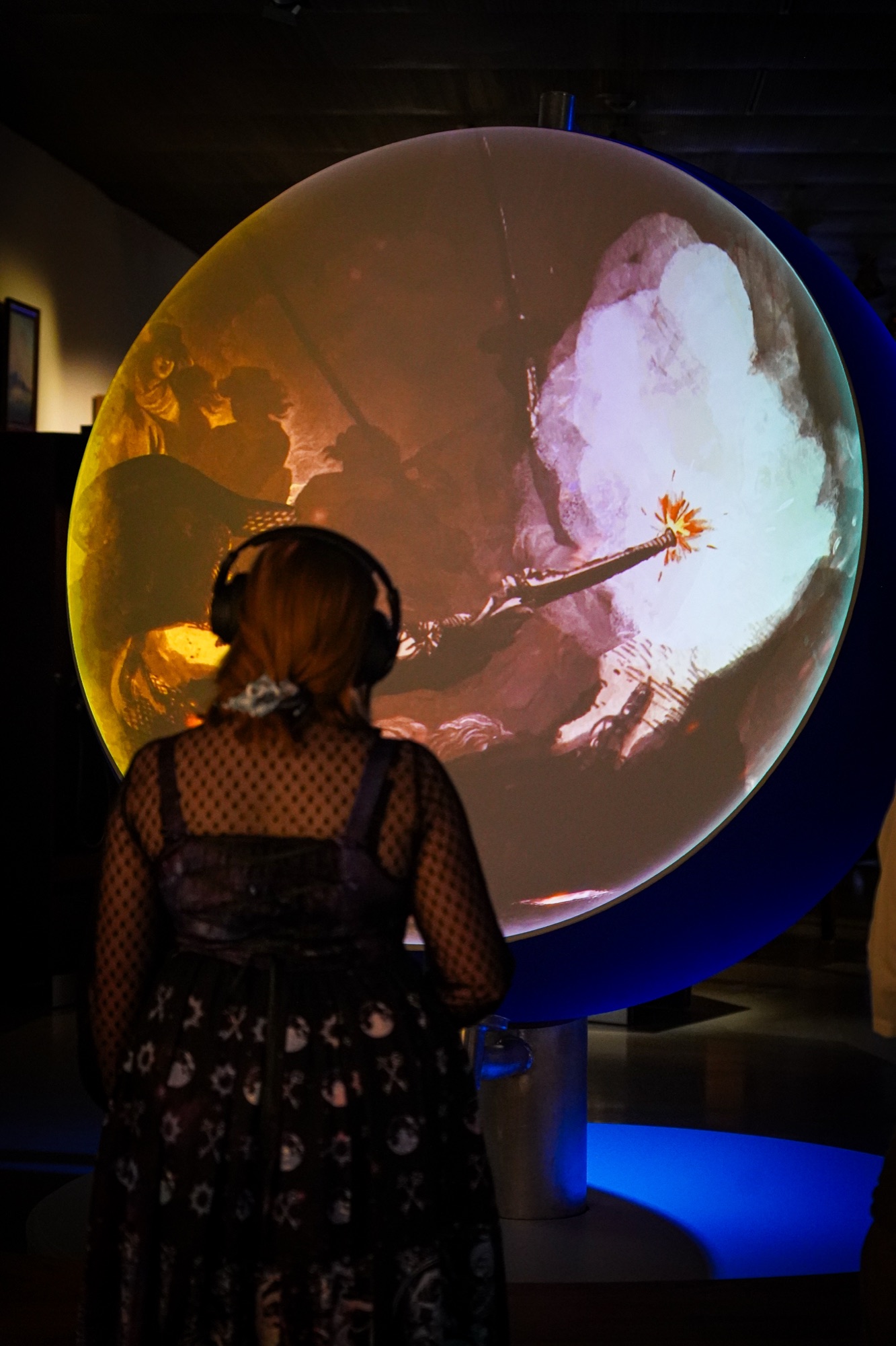 A guest in front of the globe projection
