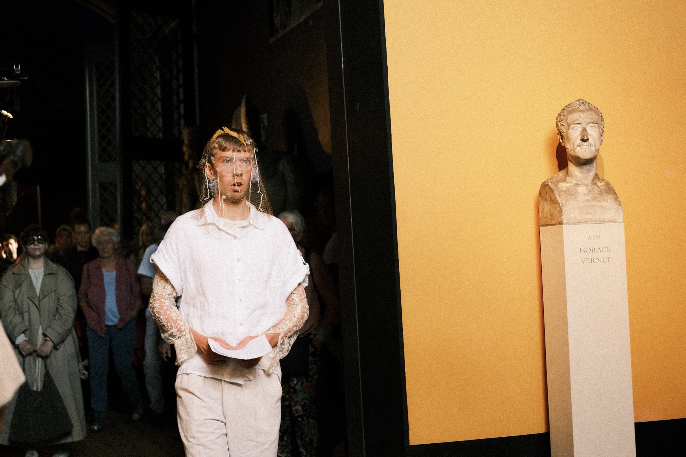 The singer leading the procession through the museum