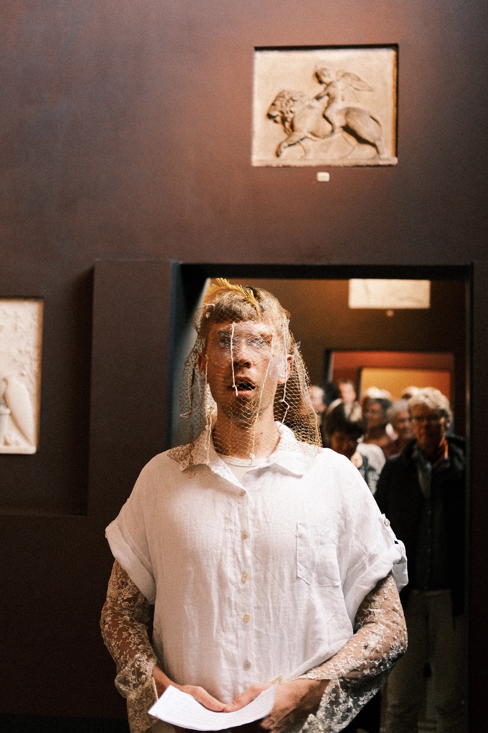 The singer in a doorway with the audience behind him